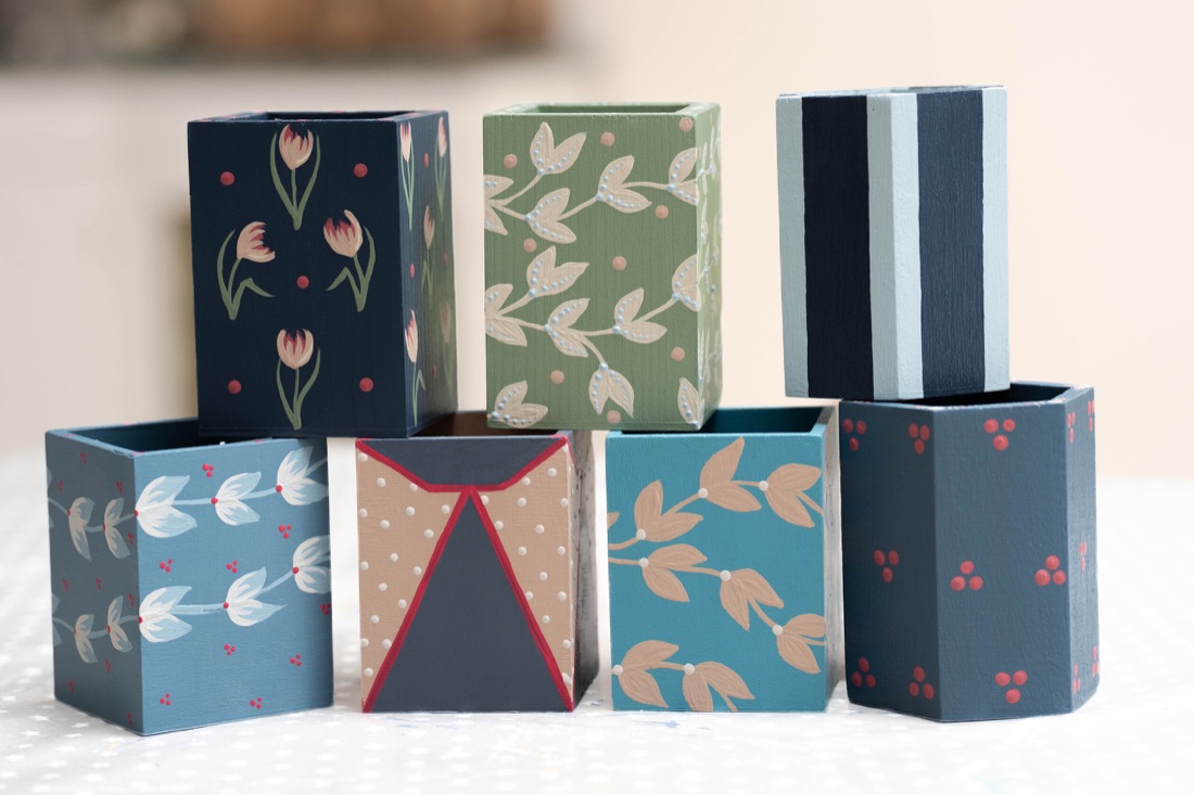 Colourful hand painted pen pots.