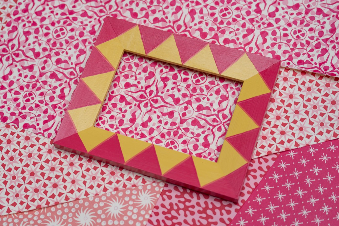 A pink and yellow diamond-painted upcycled frame.