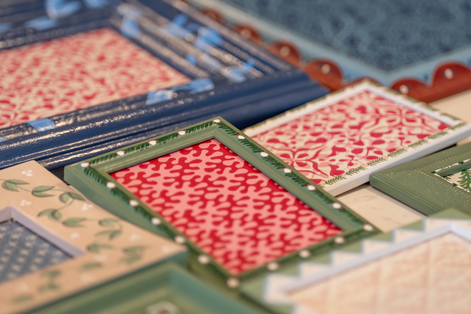 A colourful assortment of hand-painted frames, showing their textures and individual details.